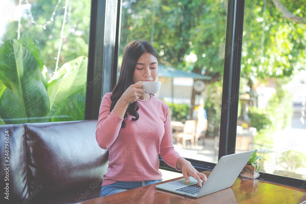 Women are selling products through social media using online notebooks at coffee shops. Women are selling products through social media using online notebooks at coffee shops.
