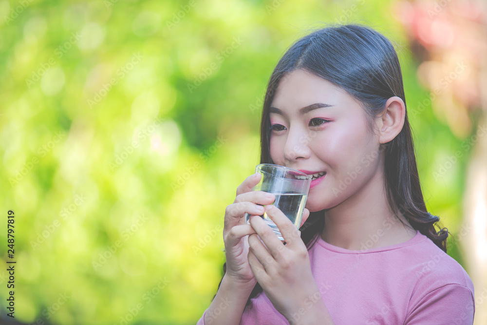 Beautiful women drink clean water from a glass of water Beautiful women drink clean water from a glass of water