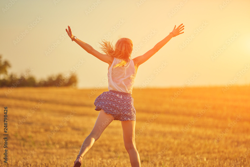 Cute young woman jumping in a wheat field. Cute young woman jumping in a wheat field.