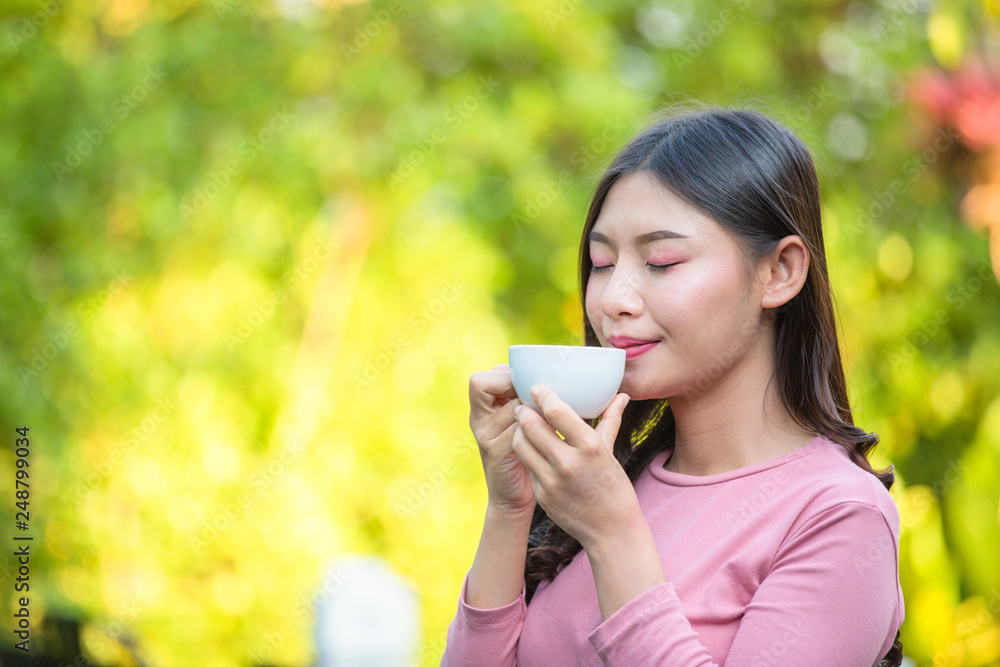 The girl is sipping coffee with pleasure at the coffee shop. The girl is sipping coffee with pleasure at the coffee shop.