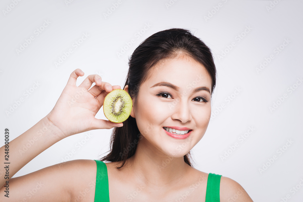 Kiwi fruit. Happy young asian woman holding kiwi fruit isolated on white background Kiwi fruit. Happy young asian woman holding kiwi fruit isolated on white background