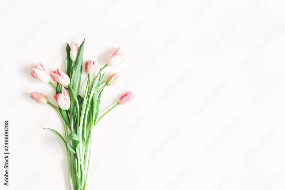 Flowers composition. Bouquet made of pink tulip flowers on white background. Valentines day, mothers day, womens day, spring, easter concept. Flat lay, top view, copy space Flowers composition. Bouquet made of pink tulip flowers on white background. Valentines day, mothers day, womens day, spring, easter concept. Flat lay, top view, copy space