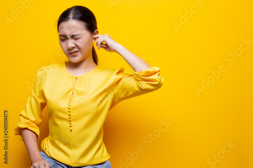 Woman putting a finger into her ear