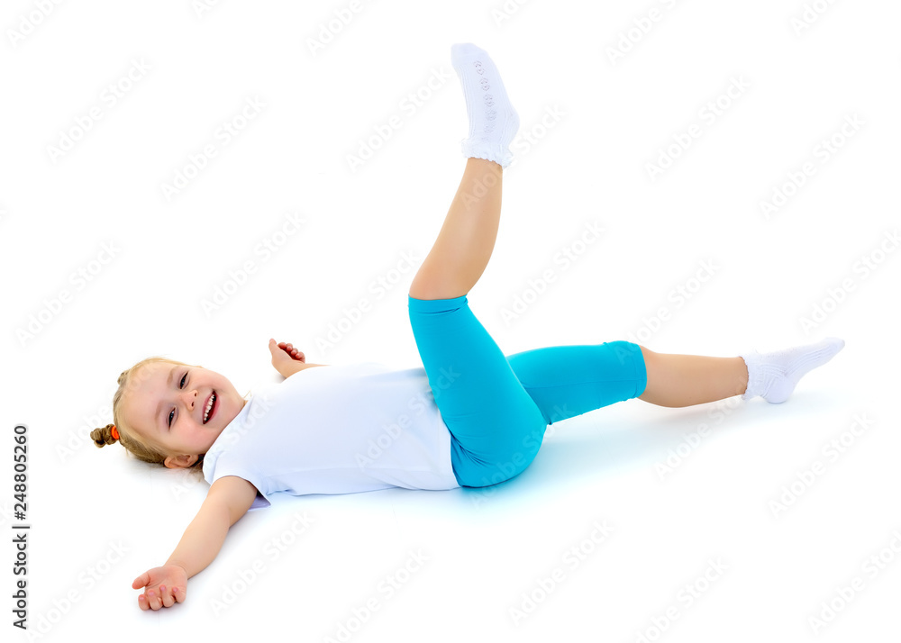 The little gymnast perform an acrobatic element on the floor. The little gymnast perform an acrobatic element on the floor.