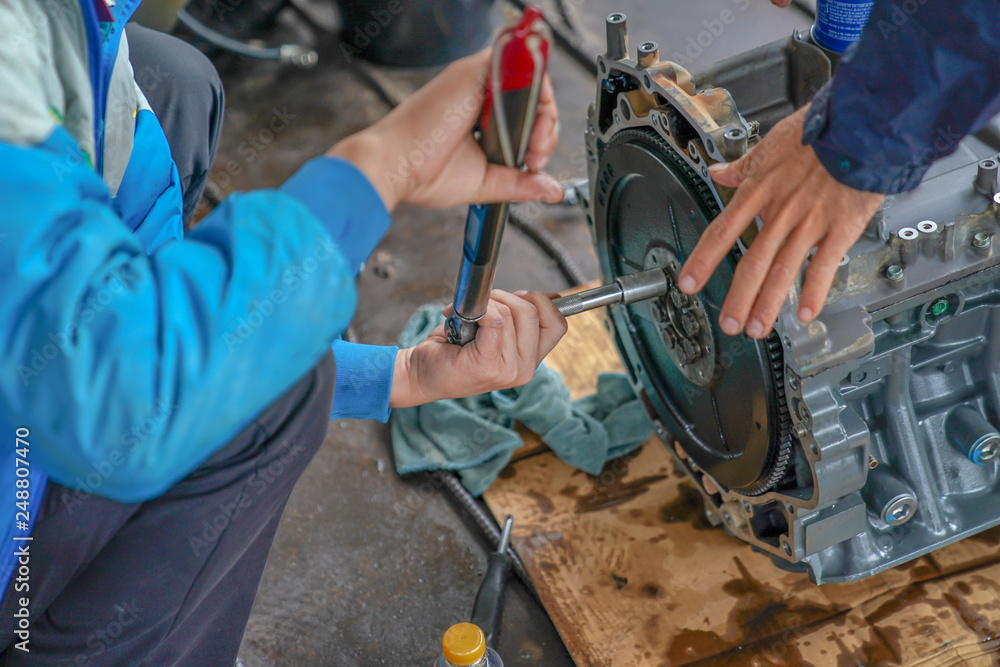 2 mechanic men try to fix and setup boat engine.