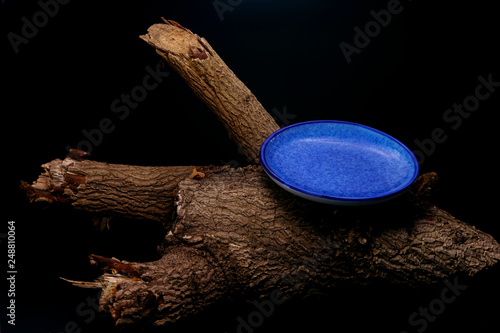 Spoon and dish on timber on black background for art decoration.