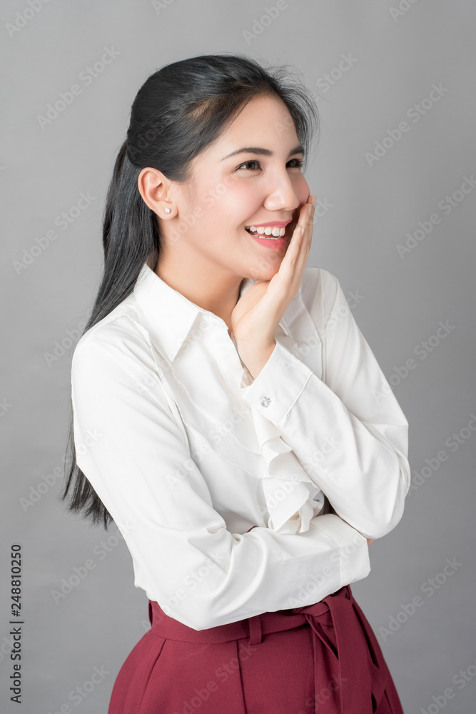 Portrait of beautiful business woman on grey background, studio shot Portrait of beautiful business woman on grey background, studio shot