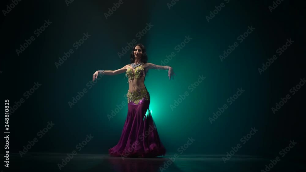 Belly dancer girl shaking her hips. Smoke background Belly dancer girl shaking her hips. Smoke background