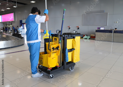 Closeup of woman cleaning worker doing her work with janitorial, cleaning equipment and tools.