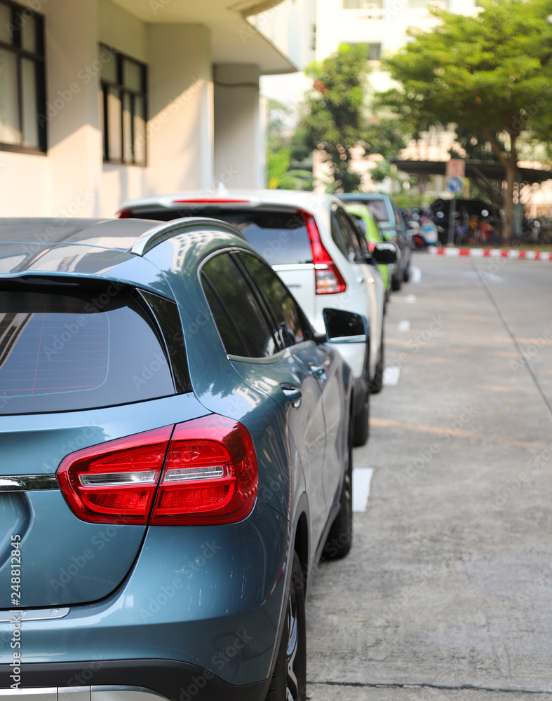 Closeup of rear or back side of blue car with other cars parking in parking area. Vertical view. Closeup of rear or back side of blue car with other cars parking in parking area. Vertical view.