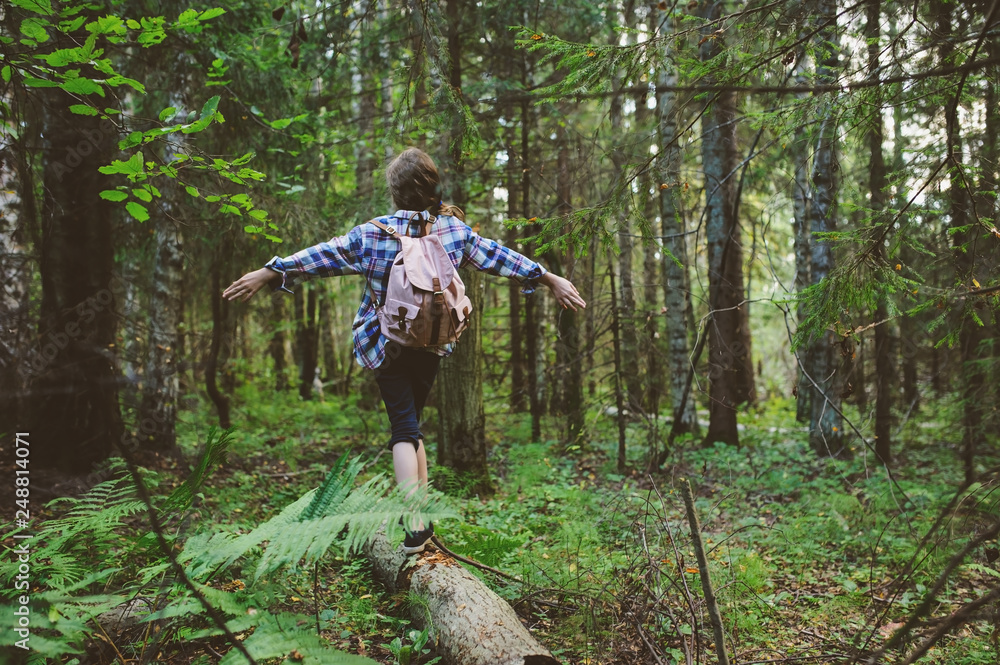 happy kid girl exploring summer forest, traveling on vacation. Teaching kids to love nature. Earth day concept. happy kid girl exploring summer forest, traveling on vacation. Teaching kids to love nature. Earth day concept.