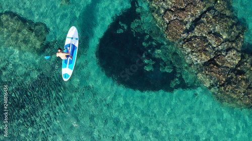 Aerial drone bird's eye view of 2 men exercising sup board in turquoise tropical clear waters © aerial-drone