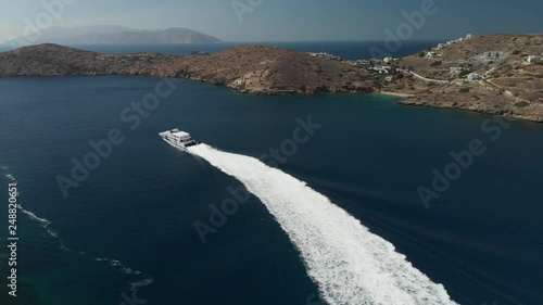 Drone footage of two motor boats floating parallelly against each other at high speed. Aerial view from Ios island in Greece. photo