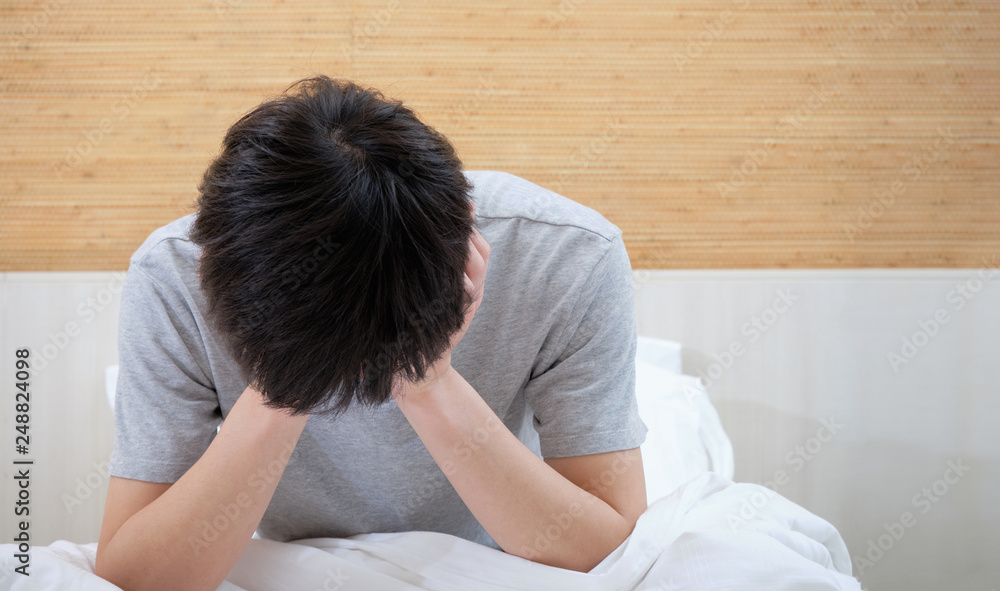 Young man have insomnia while sitting in bed. Young man have insomnia while sitting in bed.