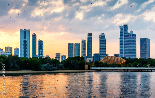 Photography Beautiful sunset over emirate of Sharjah skyline