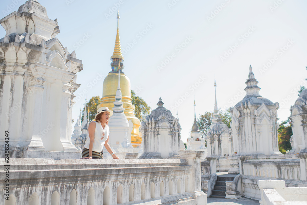 Traveller girl enjoying and looking at Buddhist stupas,Wat Suan Dok,Chiangmai,Thailand