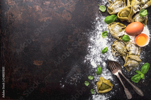 fresh basil tortellini with ingredients on a dark underground