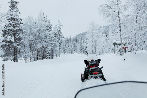 Snowmobile in a snowy lapland landscape, winter in finland. 