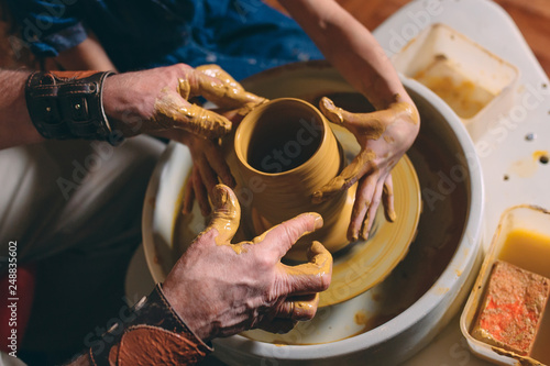 Pottery workshop. Grandpa teaches granddaughter pottery. Clay modeling