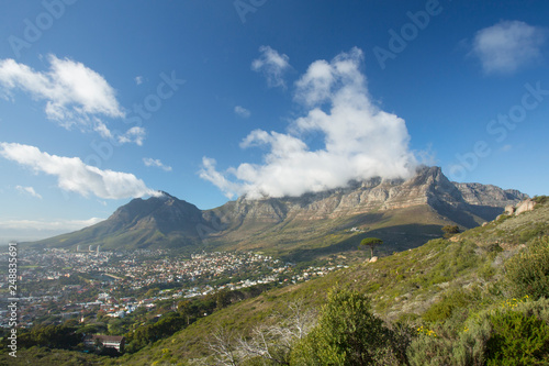 Clouds spilling over Table Mountain on a clear day, Cape Town, South Africa © Danie Nel