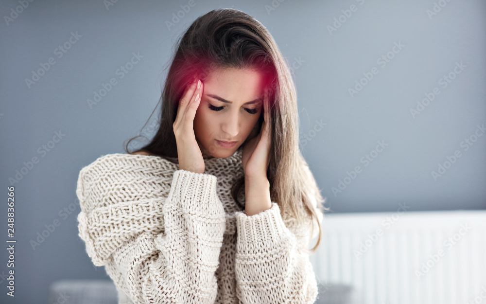 Adult woman suffering from headache at home Adult woman suffering from headache at home