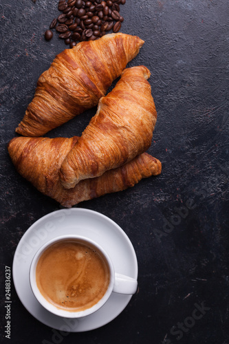 Top view of traditional croissants with hot coffee