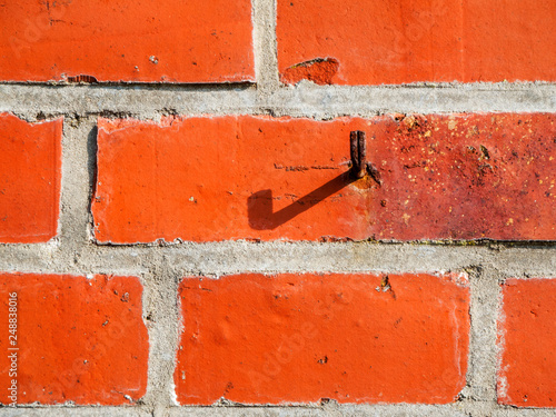 Brick background with rusty hook photo