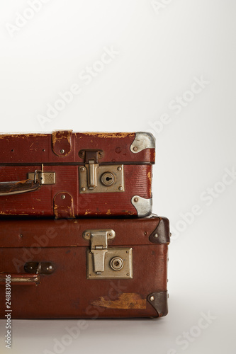 retro brown suitcases on grey background with copy space