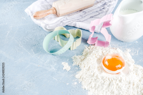 Easter baking culinary background with ingredients and props, on a light blue concrete background top view copy space