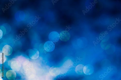 Blue bokeh background, abstract defocused lights.