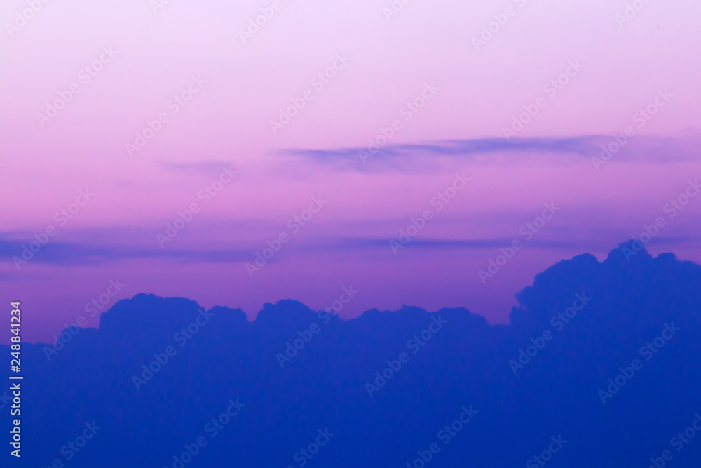 Beautiful purple-pink sky at sunset with a line of clouds