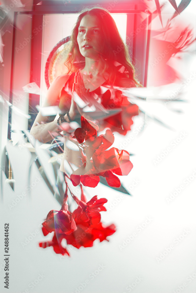 Fototapeta premium double exposure woman practising yoga and toned oleander flowering branch on white background,trendy healthy lifestyle design