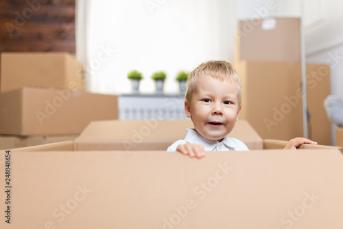 Cute toddler helping out packing boxes