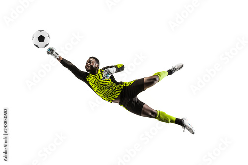 Leinwand Poster Male soccer player goalkeeper catching ball in jump