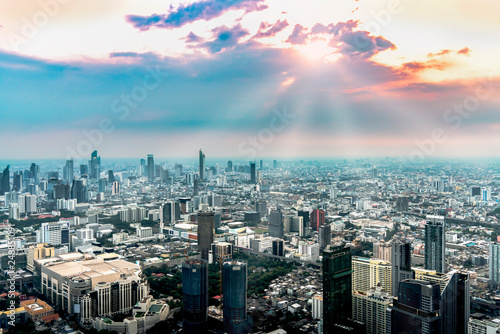 The capital city in the afternoon with the sun shining over the skyscrapers throughout the city.