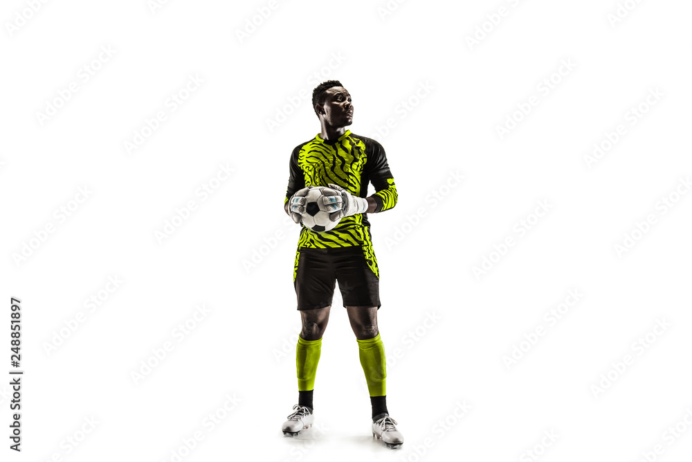 One african male soccer player goalkeeper standing and holding ball. Silhouette isolated on white studio background One african male soccer player goalkeeper standing and holding ball. Silhouette isolated on white studio background