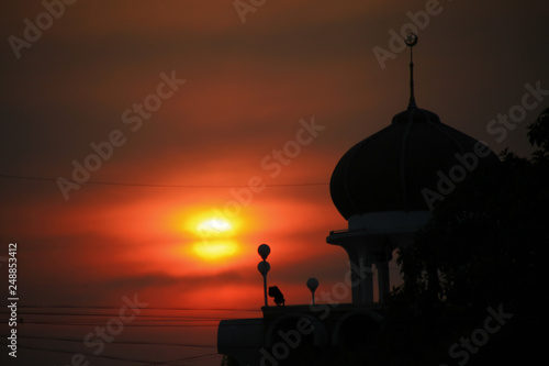 Silhouette in a sunset with a mosque 