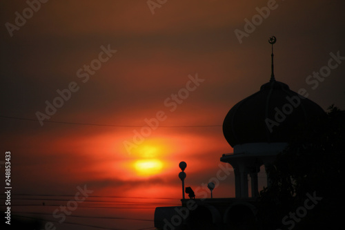 Silhouette in a sunset with a mosque 