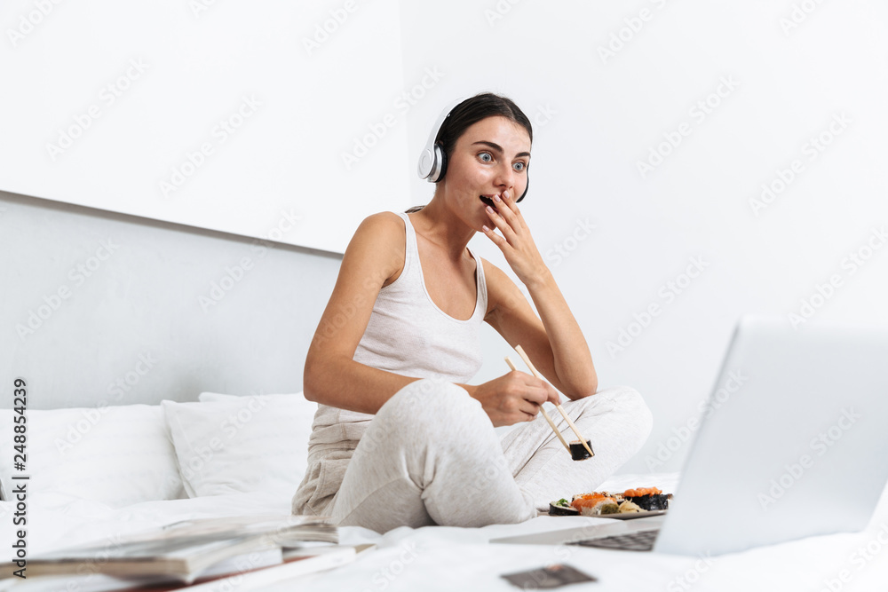 Beautiful young woman relaxing on bed at home Beautiful young woman relaxing on bed at home
