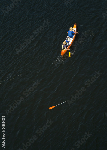 two in a kayak, one lost the paddle, top view