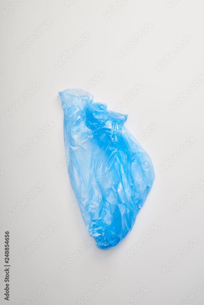 Fototapeta premium top view of blue garbage bag on white background