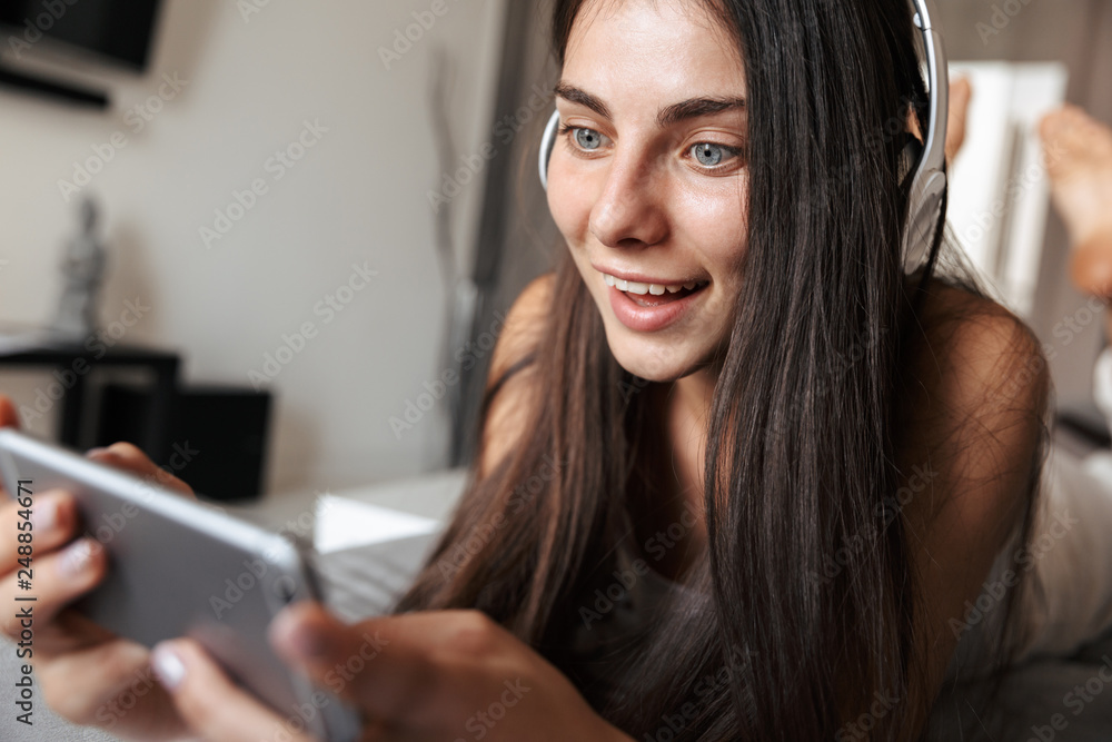 Beautiful young woman relaxing on a couch at home Beautiful young woman relaxing on a couch at home