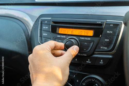Man using car audio stereo system. Car multimedia for entertainment in car.