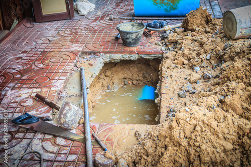 Underground PVC pipe of the water supply is broken and being repaired by the plumber.