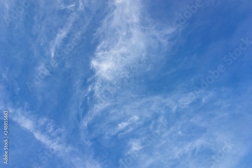 Clear blue sky with plain white cloud with space