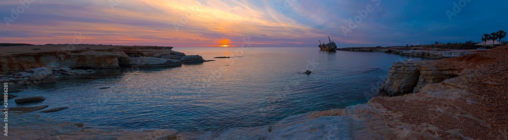 Extra wide panorama of beautiful seascape and shipwreck. Abandoned ship Edro III at sunset near the Paphos, Cyprus.