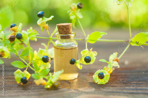 belladonna essential oil in  beautiful bottle on table photo