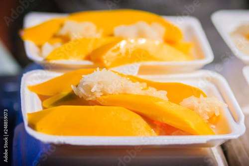 Mango with sticky rice and fresh fruit juice are the popular street foods at Khao San Road night market, Bangkok, Thailand. photo