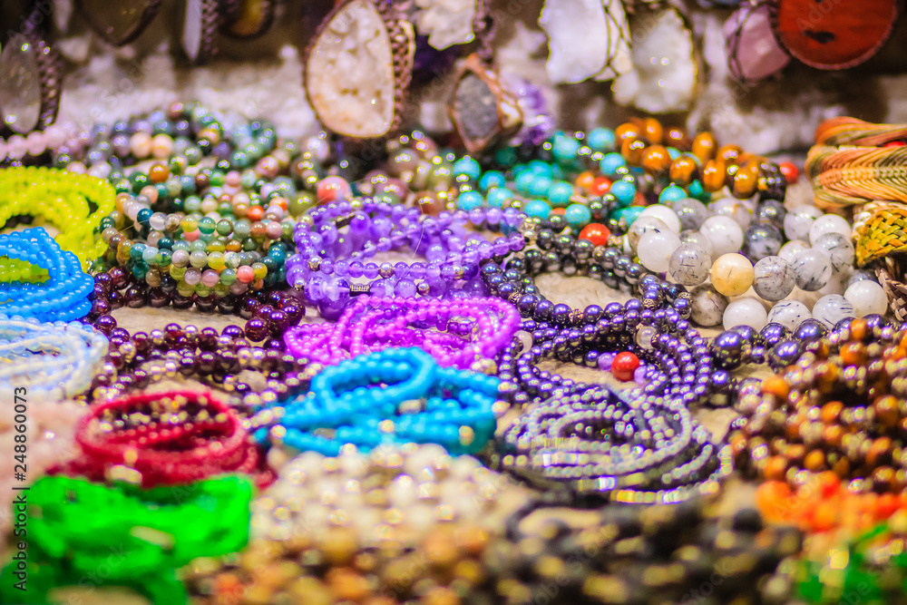 Colorful bracelets, beads and necklaces souvenir for sale on street at Khao San Road night market, Bangkok, Thailand.