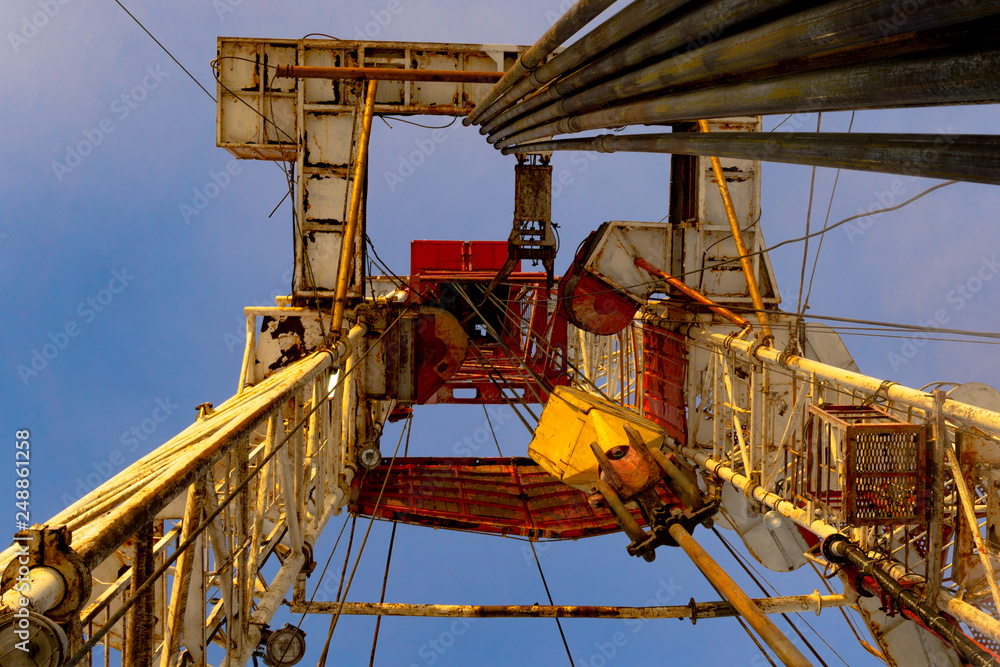Oil and Gas Drilling Rig onshore dessert with dramatic cloudscape. Oil drilling rig operation on the oil platform in oil and gas industry. Land drilling rig blue sky Oil and Gas Drilling Rig onshore dessert with dramatic cloudscape. Oil drilling rig operation on the oil platform in oil and gas industry. Land drilling rig blue sky